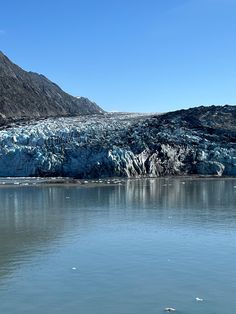 a large glacier is in the middle of a body of water