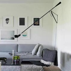 a living room filled with furniture and pictures on the wall above it's coffee table