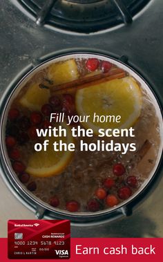 a pot filled with liquid sitting on top of a stove next to an orange slice