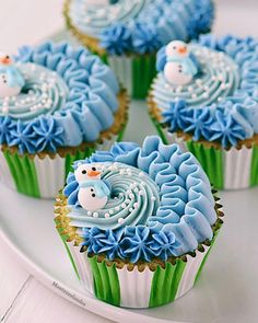 cupcakes decorated with frosting and icing on a plate