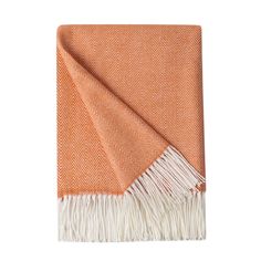 an orange and white blanket with fringes