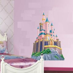 a child's bedroom decorated in pink and purple with a castle mural on the wall