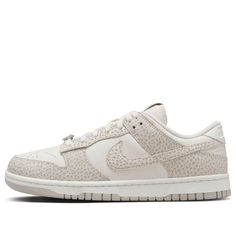 The Nike Dunk Low 'Safari Phantom' is a must-have for your collection. This women's exclusive features a premium leather upper with a subtle twist. The classic white base gets a wild makeover with overlay panels boasting a safari-inspired print in neutral tones of grey and beige. The look is grounded by a light smoke grey Swoosh and a clean white midsole. Don't miss your chance to own a piece of Nike Dunk history with a touch of safari flair! Nike Luxury Leather Sneakers, Safari Dunks, Jordan Dunk Low, Nike Dunks Low, Dunks Low, Limited Edition Sneakers, Cute Nikes, Nike Dunk Low, Grey And Beige