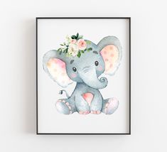 an elephant with flowers on its head is sitting in front of a white background and there is