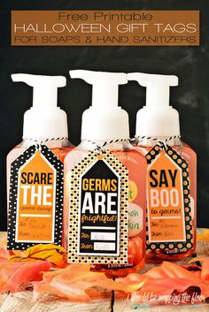 three bottles of hand sanitizers sitting on top of an orange cloth with text overlay that says free printable halloween gift tags for soaps and hand sanitizers