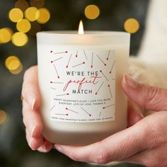 a person holding a candle in their hand with the words we're the perfect match on it