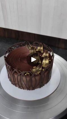 a chocolate cake sitting on top of a white plate