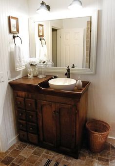 a bathroom with a sink and mirror in it