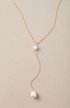 Two glowing freshwater pearls delicately station the top and bottom of this handmade Y-necklace that brings low-key elegance to any look. 16" length; 4" pendant drop Pearl size: 7–8mm 14k-gold fill/freshwater potato pearl Imported Dainty Gold Necklace With Pearl, Minimalist Pearl Lariat Necklace, Delicate Pearl Drop Lariat Necklace, Delicate Lariat Drop Necklace With Pearl, Delicate Lariat Backdrop Necklace With Pearl Charm, Minimalist Pearl Lariat Drop Necklace, Dainty Pearl Charm Lariat Necklace, Dainty Lariat Pearl Necklace With Pendant, Delicate Adjustable Lariat Necklace With Pearl Drop