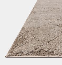 a beige rug with diamond shapes on it