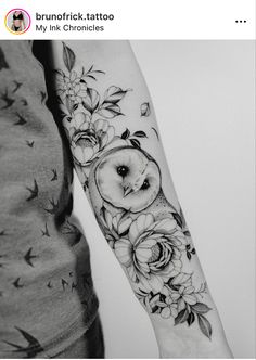 an owl and flowers tattoo on the left arm is shown in this black and white photo