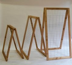 three wooden frames sitting next to each other