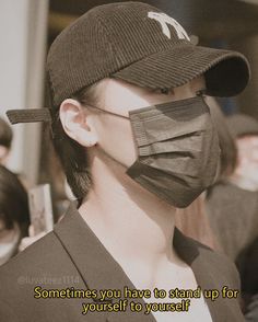 a woman wearing a baseball cap with a face mask covering her mouth and the words sometimes you have to stand up for yourself to yourself