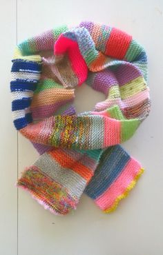 multicolored knitted scarves laid on top of each other