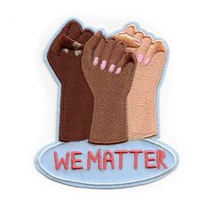 we matter embroidered iron - on patch with two hands holding each other's fists