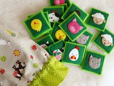 several pieces of felt with animals and sheeps on them sitting next to a cloth bag