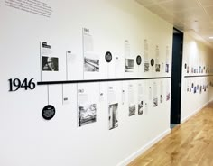 a white wall with black and white pictures on it's sides in an office