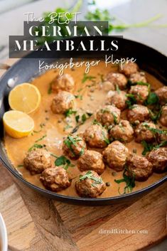 meatballs with gravy in a skillet on top of a cutting board