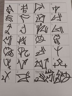 some type of calligraphy that is on top of a piece of paper with black ink