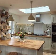 a kitchen filled with lots of counter top space and wooden stools next to an oven