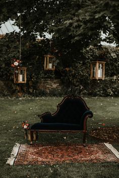 an old chair sitting on top of a rug in the grass