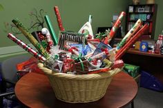 a wicker basket filled with candy canes and candies on top of a table