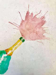 a bottle of champagne is being splashed with pink and green watercolors on white paper