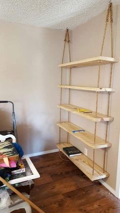 a room that has some shelves on the wall and other items in it, including bookshelves