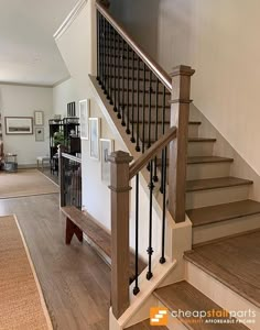 the stairs in this house are made of wood and wrought iron, with black railings on each handrail