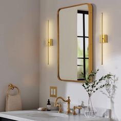 a bathroom with a sink, mirror and two lights on the wall next to it