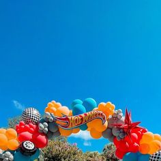 an arch decorated with balloons in the shape of cars