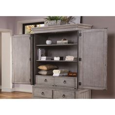 an armoire with drawers and shelves in a room