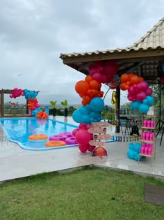 an outdoor pool decorated with balloons and streamers