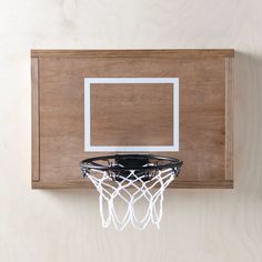 a basketball hoop mounted to the side of a wooden wall with a white net on it