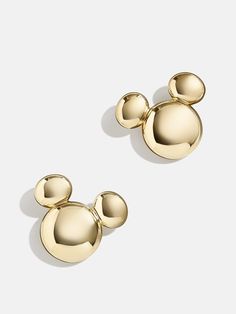 two gold mickey mouse ear studs on a white background