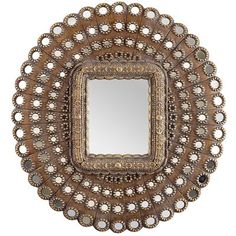 an ornate wooden mirror is shown on the white background, with small flowers and leaves around it