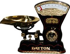 an antique style kitchen scale with a golden bowl on it's top and the words dayton written in gold