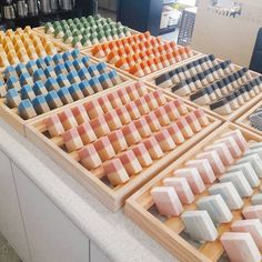 an assortment of different colored cheeses on display