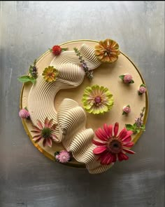 a cake decorated with flowers on top of a table