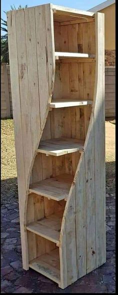 a wooden shelf sitting on top of a stone ground