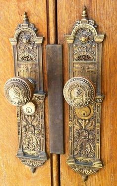 an ornate door handle on a wooden door