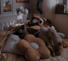 three stuffed animals laying on top of a bed