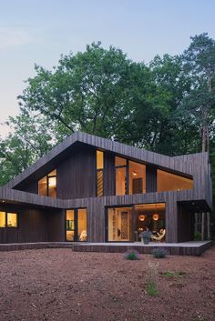 a large wooden house sitting in the middle of a forest