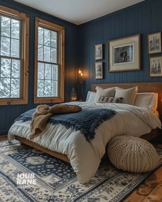 a bedroom with blue walls and white bedding in the corner, along with two windows