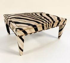 a zebra print footstool is shown on a white background with black and white stripes