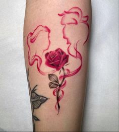 a red rose tattoo on the leg with leaves and swirls around it's petals