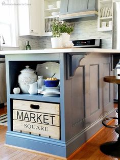 the kitchen island is painted blue and has an advertisement for market square written on it