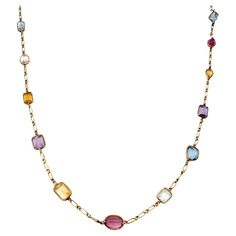 Long, luxurious multi-gemstone station necklace bursting with color. This amazing piece absolutely lights up the neck! Featuring 21 assorted bezel set gemstones on an elongated link chain, the colorful stones pop against the warm yellow gold setting. Shades of pink, blue, purple, yellow, orange and green radiate throughout the piece, each a different shape and hue. This necklace can be dressed up or down and adds the perfect pop of color to your look. The long piece can also be wrapped around th Asymmetrical Jewelry, Purple Yellow Orange, Multi Gemstone Necklace, Colorful Stones, Bezel Necklace, Gold Long Necklace, Warm Yellow, Gem Necklace, Long Chain Necklace