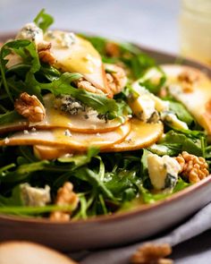 a close up of a plate of food with greens and cheese on it's side