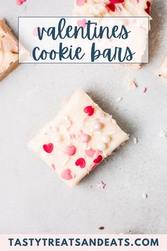 valentine's cookie bars with white frosting and sprinkles on top